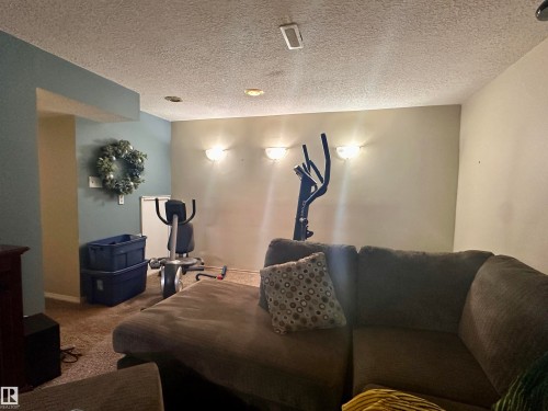 Carpeted room featuring recessed lighting and wall sconces - 10619 108 Avenue, Westlock, AB - Indoor Photo Showing Other Room