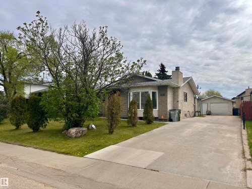 Single-story home featuring a brick facade with a prominent front window and an attached chimney - 10619 108 Avenue, Westlock, AB - Outdoor