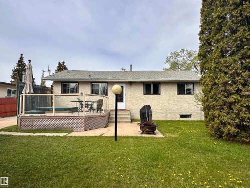Rear exterior with textured stucco finish and a shingle roof - 10619 108 Avenue, Westlock, AB - Outdoor With Deck Patio Veranda