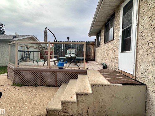 Rear deck featuring glass panel railing and lattice skirting - 10619 108 Avenue, Westlock, AB - Outdoor With Deck Patio Veranda With Exterior