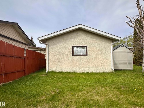 Detached stucco accessory building with a brown-framed window, white fascia, and white gutters - 10619 108 Avenue, Westlock, AB - Outdoor With Exterior