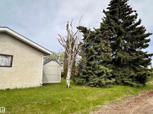 Exterior stucco finish with brown trim window - 10619 108 Avenue, Westlock, AB - Outdoor