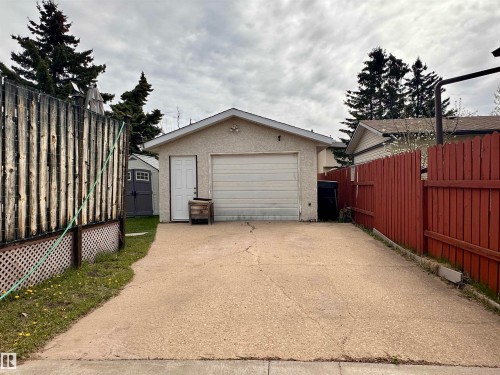 Detached garage structure featuring an overhead door and a separate entry door - 10619 108 Avenue, Westlock, AB - Outdoor