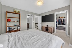 Bedroom featuring light gray walls, carpet flooring, and a flush mount ceiling light - 