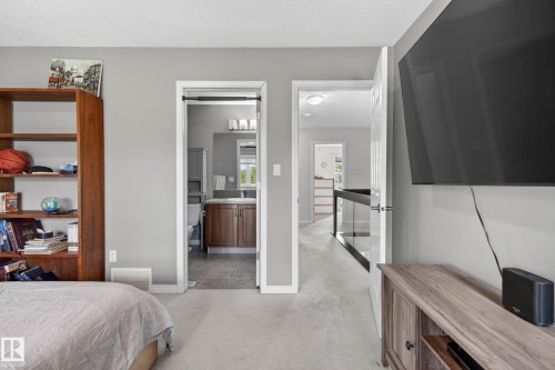 Carpeted interior space with light gray walls, featuring two doorways - 2007 72 Street, Edmonton, AB - Indoor Photo Showing Bedroom