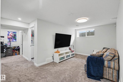 Spacious carpeted room featuring a white ceiling, recessed lighting, and a flush mount ceiling light - 2007 72 Street, Edmonton, AB - Indoor