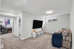 Spacious carpeted room featuring a white ceiling, recessed lighting, and a flush mount ceiling light - 