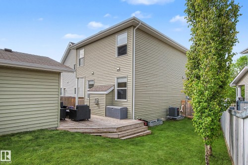 Rear exterior featuring a multi-level wood deck, a verdant lawn, and mature perimeter trees - 2007 72 Street, Edmonton, AB - Outdoor With Exterior