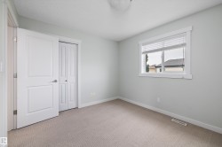 Carpeted interior space featuring a single window with blinds, a white door, and a bi-fold closet - 