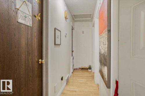 Hallway with wood-finish flooring and light-toned walls - 13224 37 Street, Edmonton, AB 