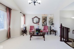 Carpeted interior space featuring light neutral wall paint - 