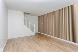 Open concept living area featuring a modern wood slat accent wall - 