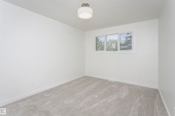 Light gray wall-to-wall carpeting complements the white walls and trim - 