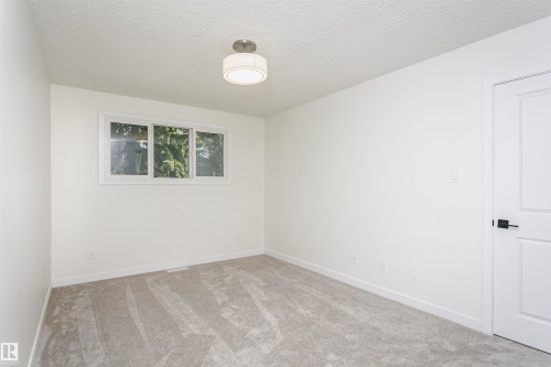 Neutral white walls and light gray carpeting create a versatile interior - 5418 144B Avenue, Edmonton, AB 