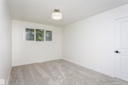 Neutral white walls and light gray carpeting create a versatile interior - 