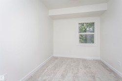 Neutral wall color with white trim, a double-hung window, and light gray carpet - 