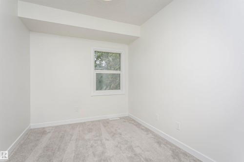 Room with neutral gray carpet, white walls, and a white-framed window - 5418 144B Avenue, Edmonton, AB 