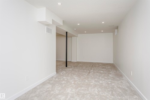 Open concept room featuring recessed lighting, light-toned carpeting, and crisp white walls - 5418 144B Avenue, Edmonton, AB 