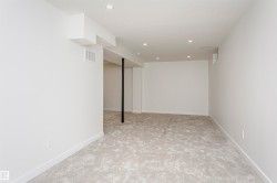 Open concept room featuring recessed lighting, light-toned carpeting, and crisp white walls - 