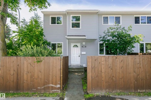 Two-story residential building with light gray horizontal siding and white trim - 5418 144B Avenue, Edmonton, AB 
