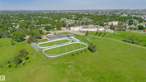 Expansive green space featuring multiple sports fields and a fenced track facility - 5418 144B Avenue, Edmonton, AB 