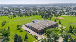 Expansive institutional building featuring a flat roof and brick facade - 