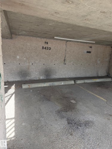 Designated parking space featuring a concrete wall with unit numbers - 8433 29 Avenue, Edmonton, AB - Outdoor