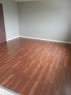 Wood-finish flooring throughout, complemented by light-toned wall paint and white baseboards - 8433 29 Avenue, Edmonton, AB  - Indoor Photo Showing Other Room 