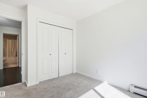 Neutral-toned carpeting paired with white walls - 435 5515 7 Avenue, Edmonton, AB 