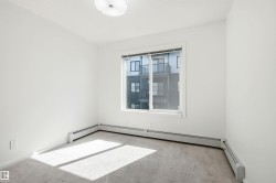 Neutral-toned carpeting complements bright white walls - 