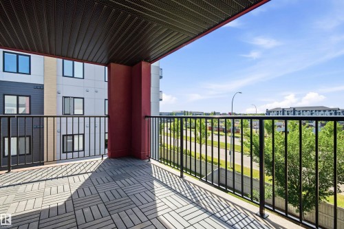 Spacious balcony featuring geometric pattern tile flooring and black metal railings - 435 5515 7 Avenue, Edmonton, AB 