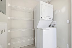 Dedicated laundry area featuring a white Frigidaire stacked washer and dryer unit - 
