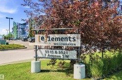 Modern apartment complex with a contemporary sign, mature landscaping, paved parking area, and multi-story buildings - 