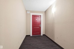 Vibrant red entry door with white trim, set against neutral wall tones - 