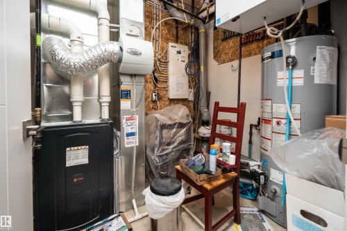 Utility space featuring a water heater and furnace with associated ductwork - 4714 Charles Bay Bay, Edmonton, AB 