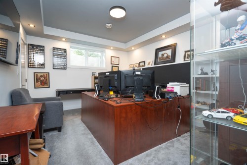 Dedicated workspace featuring a wood-finish desk, recessed lighting, and a neutral color palette - 4714 Charles Bay Bay, Edmonton, AB 