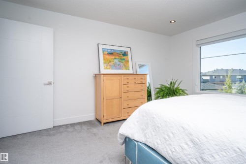 Light-filled interior featuring a large window, recessed lighting, white walls, and gray carpeting - 4714 Charles Bay Bay, Edmonton, AB 
