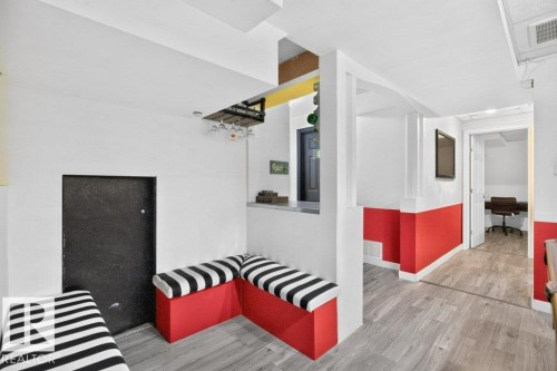 Lower level space featuring wood-finish flooring and a built-in bench seating area - 21320 90 Avenue, Edmonton, AB 