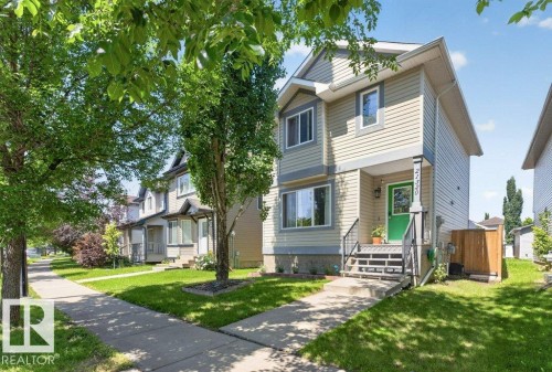 Two-story residence featuring light beige siding and dark trim - 21320 90 Avenue, Edmonton, AB 