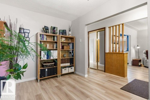 Light wood-finish flooring extending throughout the space - 10235 74 Street, Edmonton, AB 