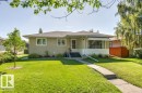 Single-story residence featuring a stucco exterior and a bay window with an awning - 10235 74 Street, Edmonton, AB 