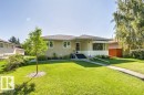 Single-story residence featuring a stucco exterior and a dark shingle roof - 10235 74 Street, Edmonton, AB 