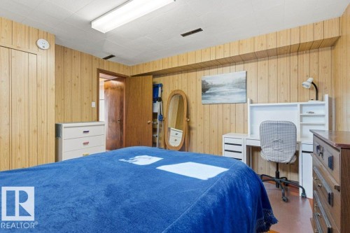 Wood-paneled room with a dropped ceiling - 10235 74 Street, Edmonton, AB 