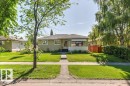 Single-story residence featuring a neutral-toned exterior, gabled roof, and a prominent front bay window with an awning - 10235 74 Street, Edmonton, AB 
