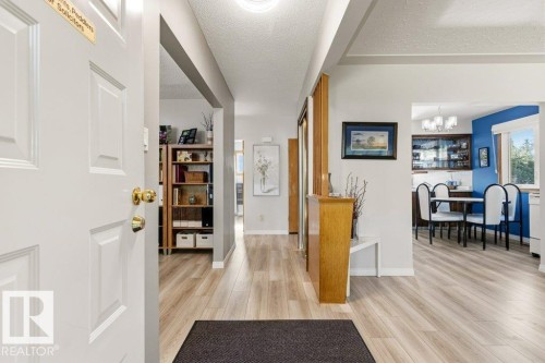 Entryway featuring wood-finish flooring and light gray walls - 10235 74 Street, Edmonton, AB 
