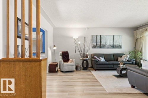 Living area featuring light wood-finish flooring and a neutral color palette - 10235 74 Street, Edmonton, AB 