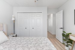 White paneled bi-fold closet doors with black hardware - 