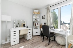 Bright room featuring light wood-finish flooring and a large picture window - 