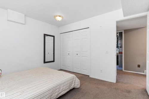Neutral wall colors complement the ceiling light fixture and textured ceiling - 15252 81 Street, Edmonton, AB 