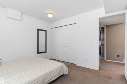 Neutral wall colors complement the ceiling light fixture and textured ceiling - 